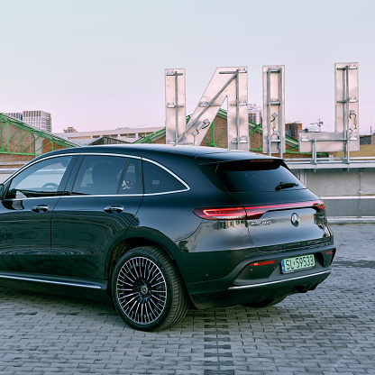 Mercedes EQC all-electric sports SUV. Rear of car. Old industrial buildings in the background. The car has a 408HP. Range (WLTP) 369-414 km. Katowice, Poland- 10.06.2020