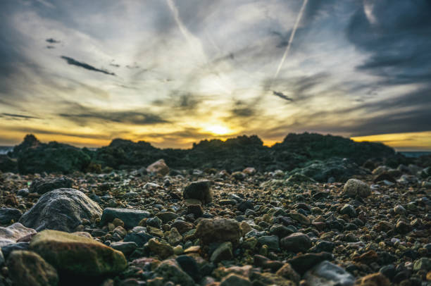Coastal Majesty: Waves Crashing Against Rocks at Sunset