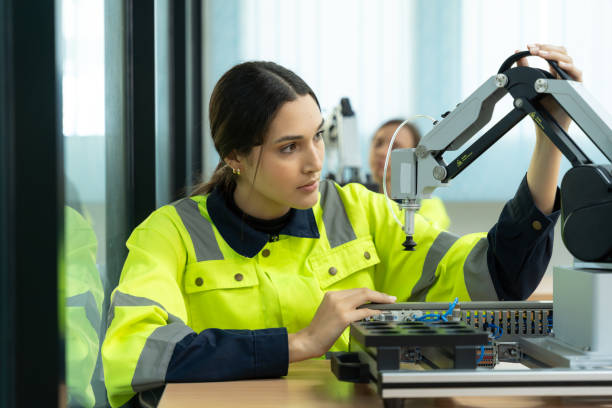 istock Engineer in Safety Vest Operating Industrial Robot. 2086732536