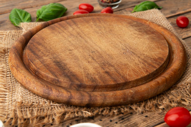 istock Empty round wooden cutting board for food, pizza. Mock up 2086752682