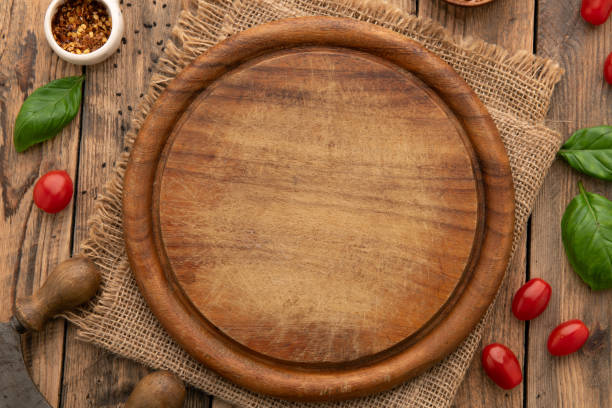 istock Empty round wooden cutting board for food, pizza. Mock up 2086753544