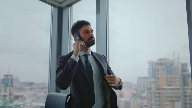 istock Business man talking phone standing at office window close up. Manager calling 2086754295