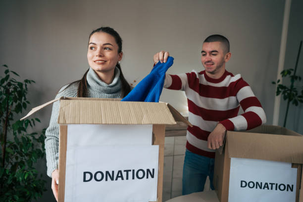 istock Young married couple packing their clothes for charitable organisation 2086762378