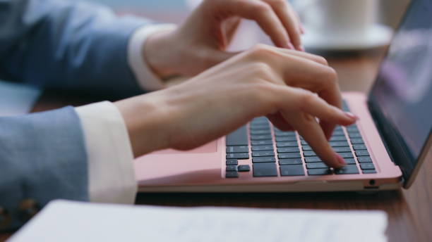 istock Woman hands typing laptop keyboard at office workplace close up. Worker writing 2086765570