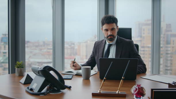 istock Pensive manager making notes working by laptop closeup. Ceo writing ideas office 2086776625