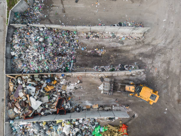 istock Wheel loader on the landfill site scooping and carrying waste, drone shot 2086778194