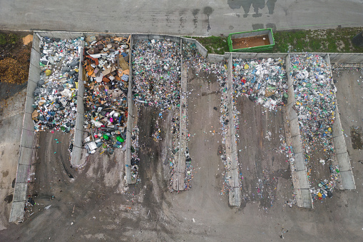 Landfill site, a pile of stinky different junk disposal in the concrete section for unsorted waste materials