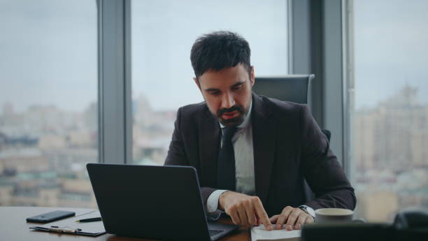istock Manager talking online interview looking laptop camera in luxury office close up 2086794543