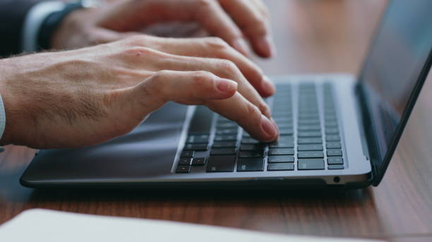 istock Businessman hands texting laptop making notes in notebook close up. Man typing 2086820497