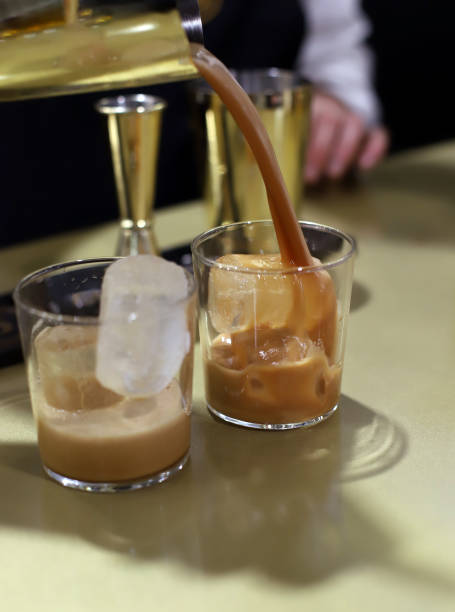 istock bartender serving cocktail with ice and coffee cream liqueur 2086856437
