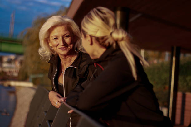 istock Two women positive emotion talking on street 2086862849