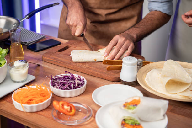 istock Cropped view of chef influencers presenting fresh salad roll. Sellable. 2086882202