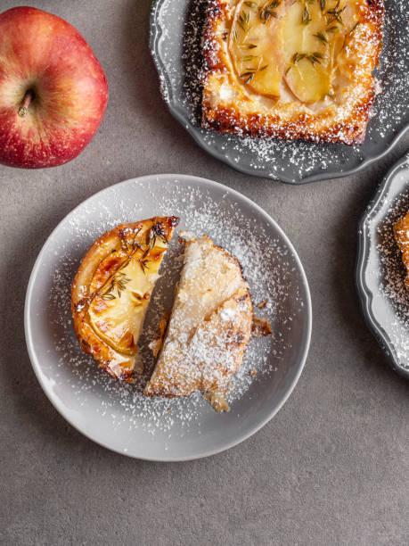 Homemade apple pies on a rustic background, top view, copy space. Classic autumn. Pastors dessert for Thanksgiving - organic apple pie.Wooden background.