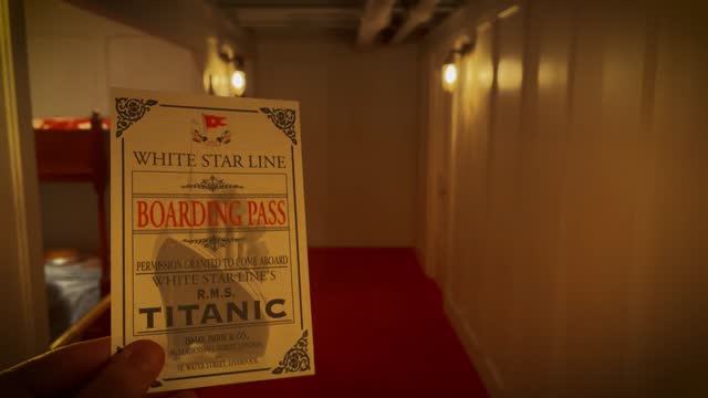 Man holds up a boarding pass in the Titanic in 1912 - Sepia grade version