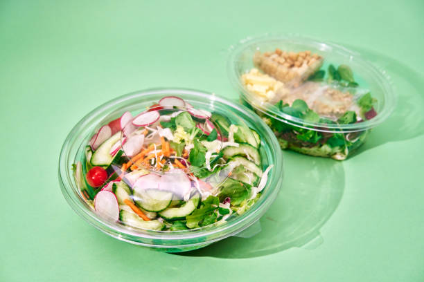 istock Various Salad Bowls in Plastic Container on Green Background 2086902681