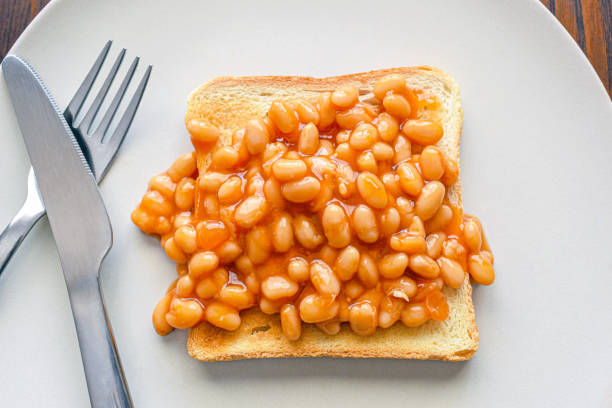 istock Beans on toast with fork and knife. 2086908411