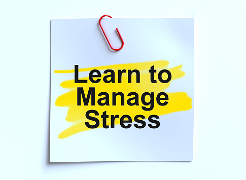 Learn To Manage Stress written on paper note