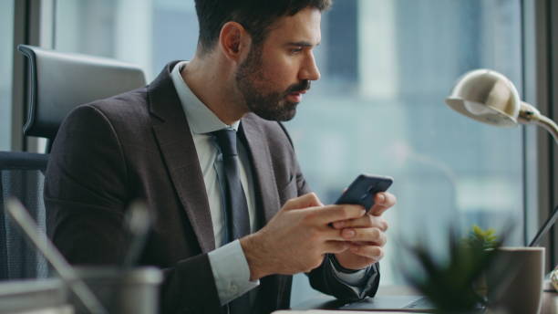 istock Focused director typing smartphone sending business email sitting office closeup 2086960067