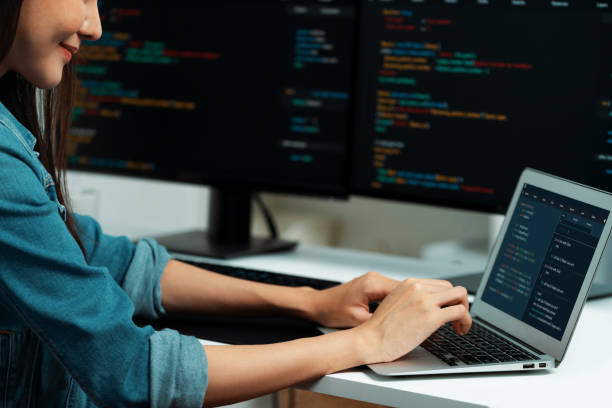 istock Smiling Asian IT typing online software development on laptop. Stratagem. 2086960156