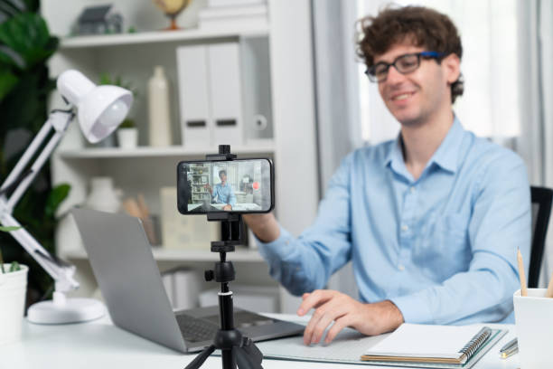istock Influencer using phone streaming online focusing phone with portrait. Gusher. 2086960282