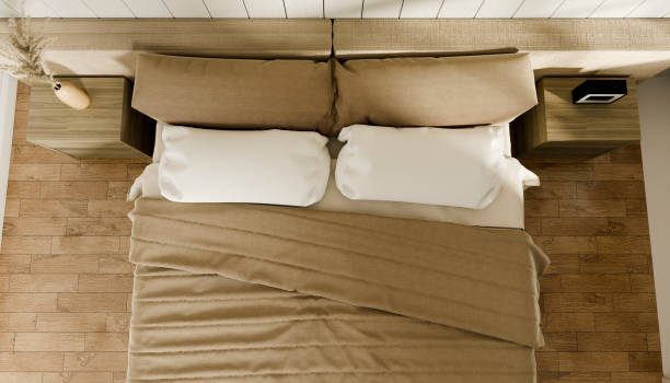 istock High angle view of a bedroom bed with blanket and pillows in a three-dimensional render image 2086960353