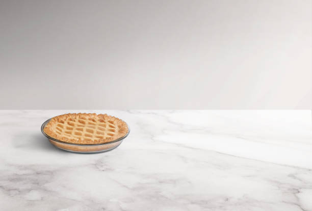 istock Baked apple pie in a pan on a white marble counter 2086971845