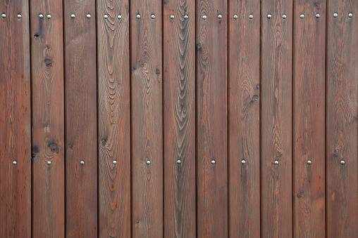 Brown wooden background of linear planks