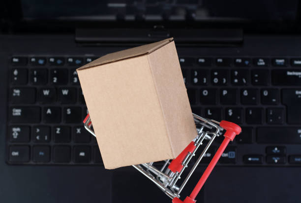 istock Shopping cart with small box on laptop keyboard 2086977192