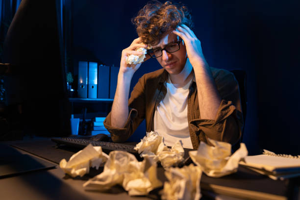 istock Stressful creative working overworked project surrounded crumpled paper. Gusher. 2086989504