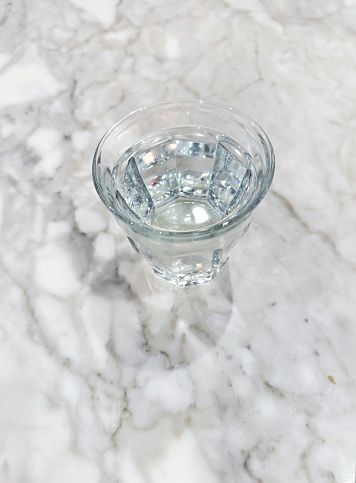 Drinking water glass on a marble table top