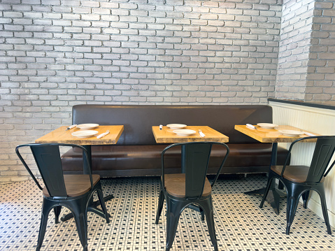 Restaurant tables side by side in a cafe with chic mosaic tiled floor