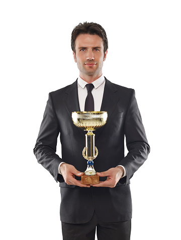 Businessman holding a trophy on white background