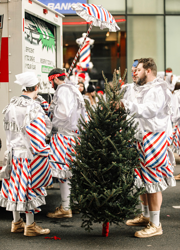 Parade participants dressed in Christmas tree costumes at the Mummers Parade in Philadelphia Pennsylvania on January 1, 2024