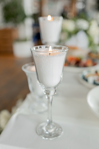 an Elegant candlelit dinner, fine glassware, romantic ambiance.