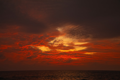 stunningly beautiful bright red dramatic sunset sky over indian ocean in sri lanka. beautiful photo wallpaper and natural background.