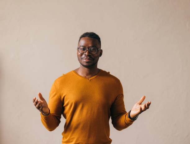 istock Smiling Confident Man in Casual Attire Gesturing with Hands 2087154871