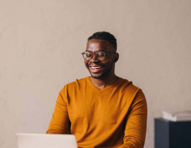 istock Smiling Young Man with Glasses Using Laptop Indoors 2087154893