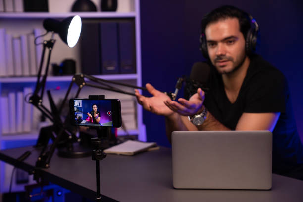 istock Broadcaster talking to listener on live streaming, recording phone. Surmise. 2087178393