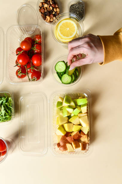 istock Female Preparing Multiple Salad Meal In Plastic Containers 2087186585