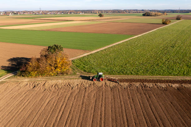 istock Aerial view of a tractor plowing field 2087202479