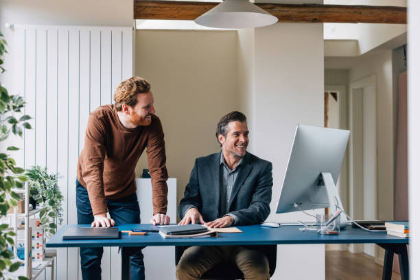 istock Two Professional Colleagues Collaborating Smilingly at a Modern Office Desk 2087206086