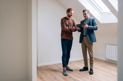 Business associates sharing ideas using a digital tablet in a modern office setting.