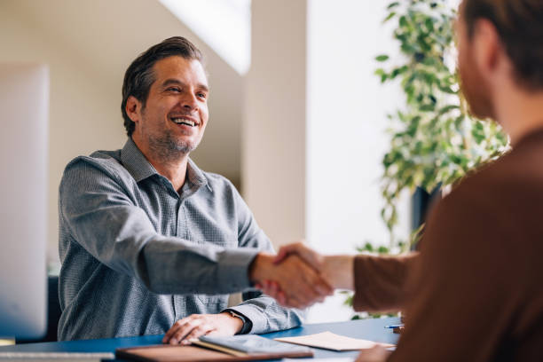 istock Smiling Businessman Handshaking Partner After Successful Meeting 2087206633