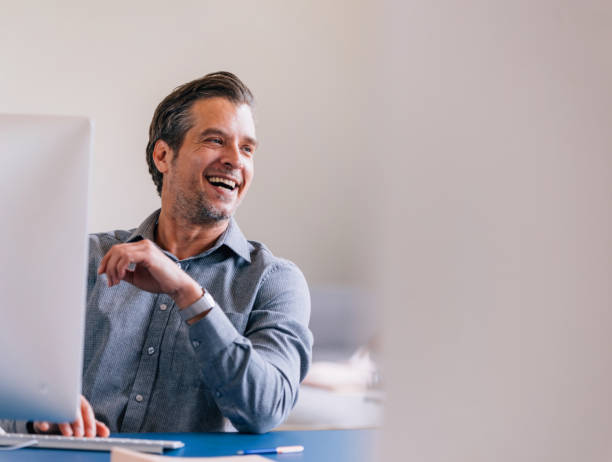 istock Smiling Businessman Enjoying Success at Workplace in Office (Copy Space) 2087206637