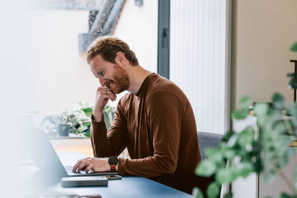 istock Focused Businessman Working on Laptop in a Modern Office Setting 2087206653