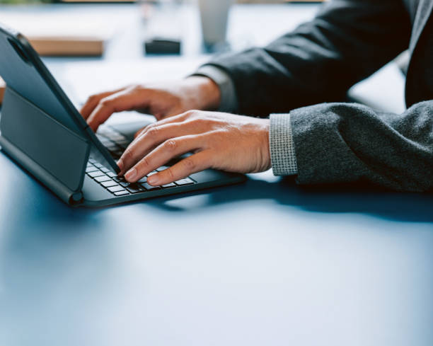 istock Professional Businessman Typing on Tablet at Work Desk 2087206665