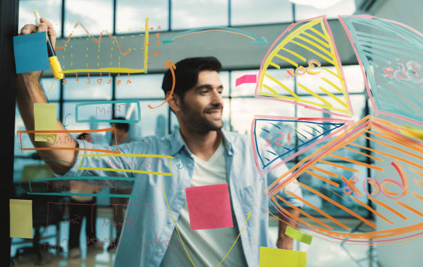 istock Smiling smart businessman writing while thinking about business plan. Tracery. 2087228250