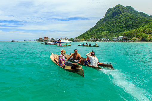 Semporna Sabah, Malaysia - Oct 18, 2017: Sea gypsy paddling a boat in Semporna, Sabah, Malaysia.