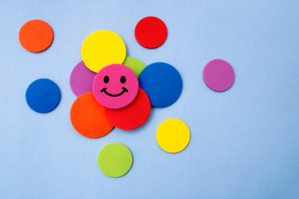 Circle with expression of happiness on other circles of different colors