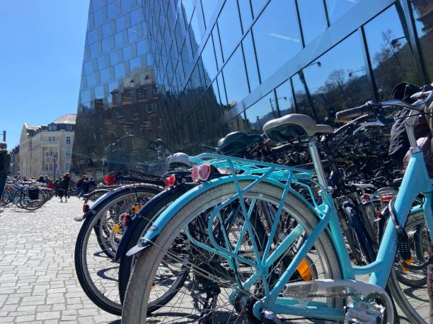 Freiburg, Germany - April 4, 2023 : Close-up of bicycles parked in front of the glass facade of the Universitätsbibliothek aka Freiburg University Library designed by Degelo Architekten in Freiburg im Breisgau